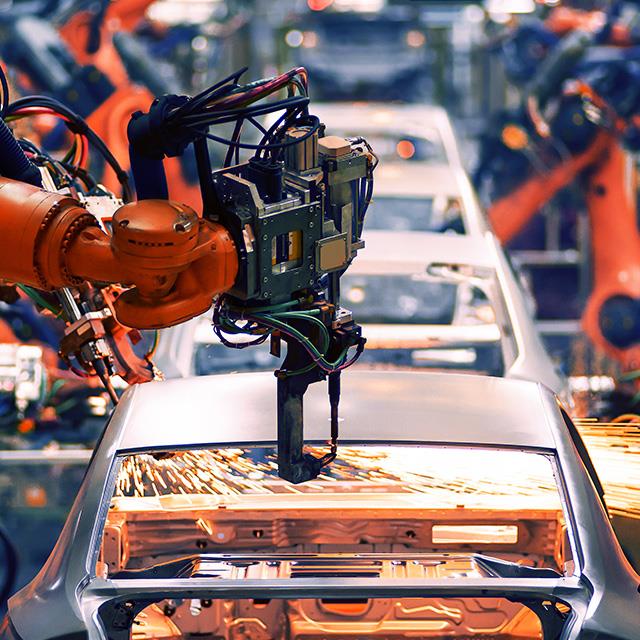 robot arm throwing sparks in automobile assembly line production