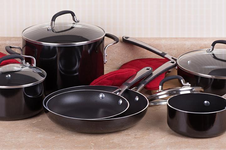 a black cookware set of 4 lidded pots and 2 frying pans