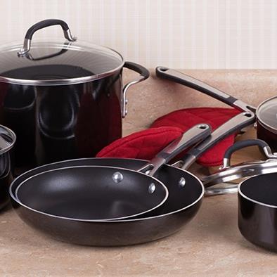 a black cookware set of 4 lidded pots and 2 frying pans