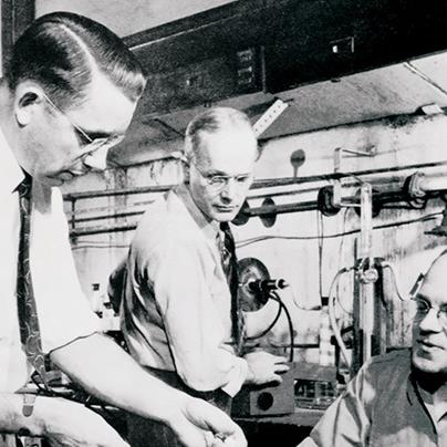 black and white photo of dr roy plunkett and two other dupont chemists